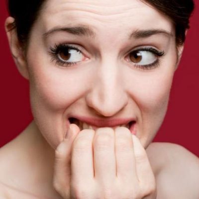 How to Act Around Your Ex (If You Want Them Back) woman biting her nails