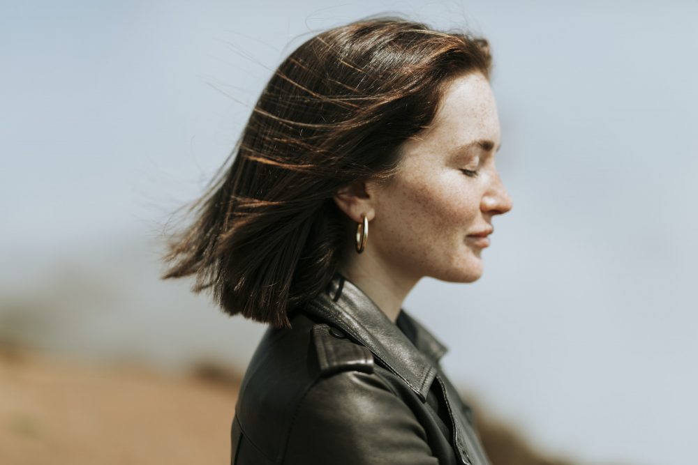 woman-smiling-closed-eyes