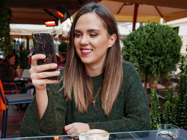 woman-smiling-at-phone