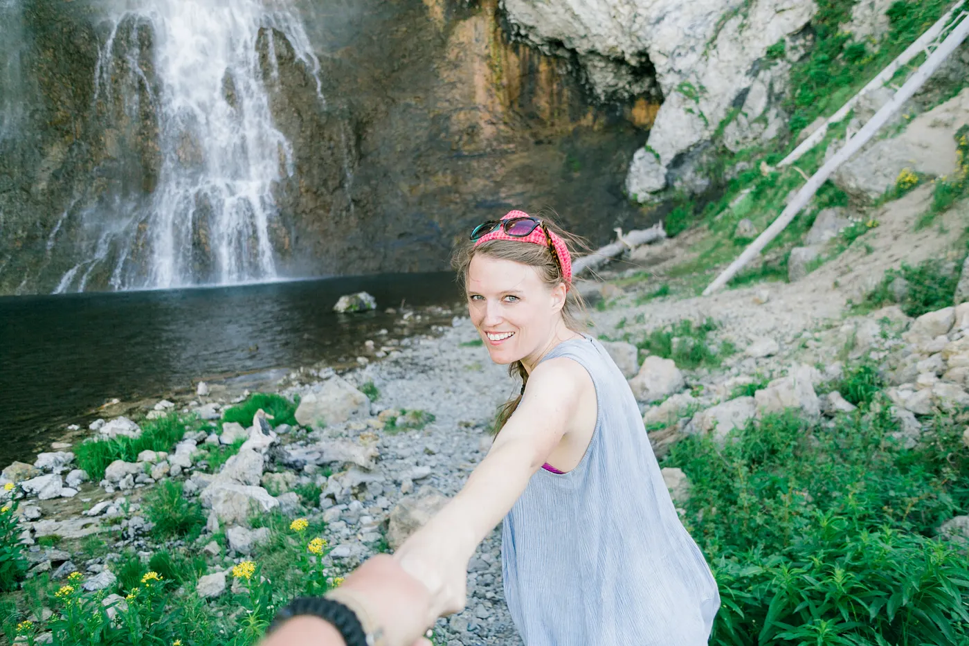 woman-holding-hand-waterfall