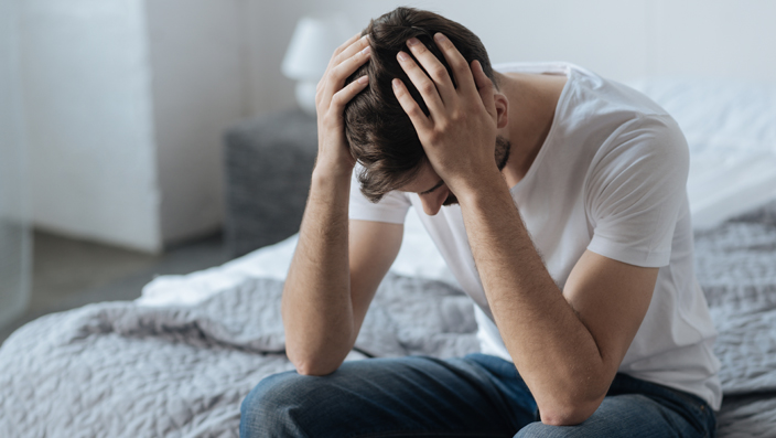despondent-man-on-bed